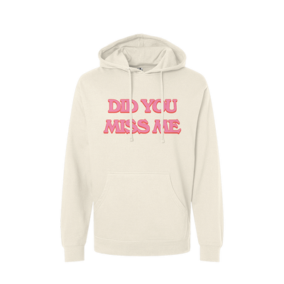 Cream-colored hoodie with pink text reading ’DID YOU MISS ME’ on the front.